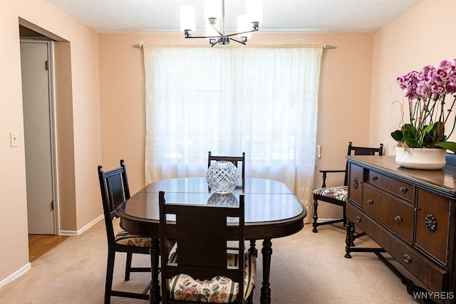 18 Tree Top Dr, Penfield, NY 14625 - dining room with light carpet, a chandelier, and baseboards