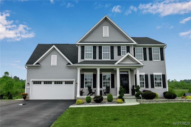 392 Quarry Run, Grand Island, NY 14072 - view of front of house with a porch, driveway, a front lawn, an attached garage, and roof with shingles
