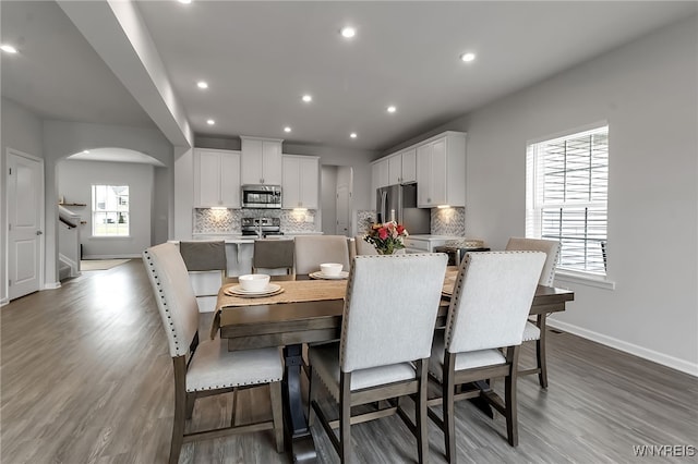 392 Quarry Run, Grand Island, NY 14072 - dining room featuring arched walkways, baseboards, plenty of natural light, wood finished floors, and recessed lighting