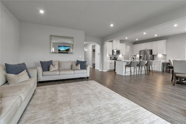 392 Quarry Run, Grand Island, NY 14072 - living area with arched walkways, recessed lighting, and dark wood-style floors