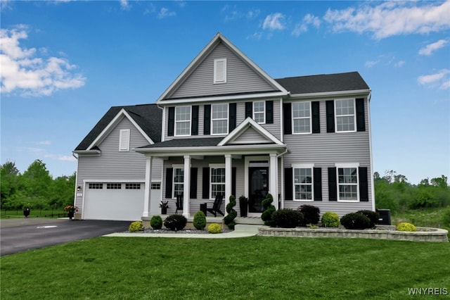 392 Quarry Run, Grand Island, NY 14072 - view of front of house featuring covered porch, a garage, asphalt driveway, a front yard, and central AC unit