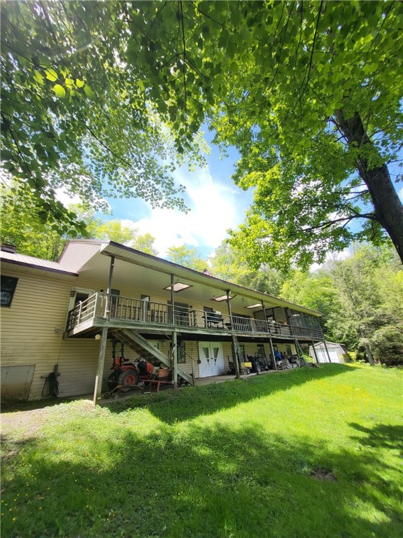 104 Mcclure Dr, Sanford, NY 13754 - rear view of house featuring a deck, a lawn, stairs, and a metal roof