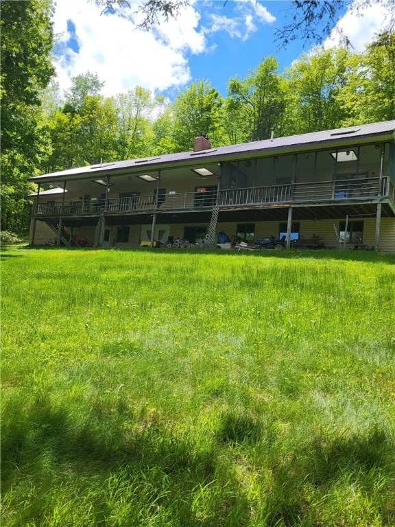 104 Mcclure Dr, Sanford, NY 13754 - rear view of property with a chimney and a wooden deck