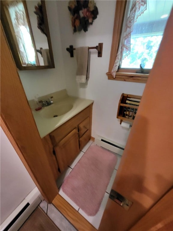 104 Mcclure Dr, Sanford, NY 13754 - bathroom featuring baseboard heating, a baseboard radiator, vanity, and tile patterned flooring