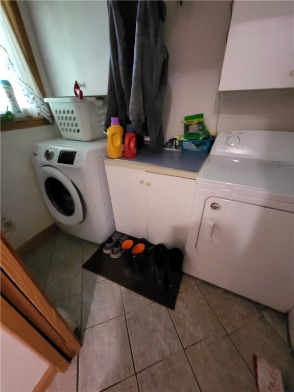104 Mcclure Dr, Sanford, NY 13754 - laundry area with washing machine and clothes dryer, cabinet space, and light tile patterned floors
