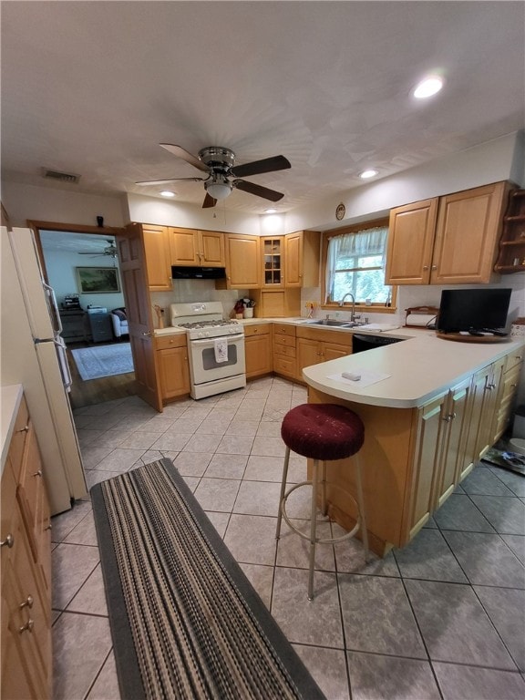 104 Mcclure Dr, Sanford, NY 13754 - kitchen with white appliances, under cabinet range hood, a peninsula, a breakfast bar, and light countertops