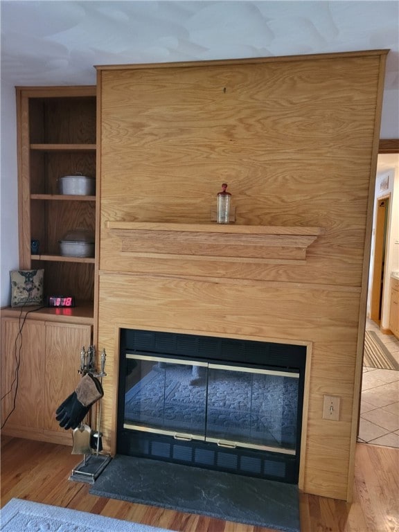 104 Mcclure Dr, Sanford, NY 13754 - detailed view of a glass covered fireplace, wood finished floors, and built in features