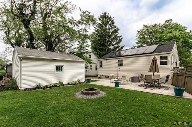 236 Commodore Ter, Cheektowaga, NY 14225 - rear view of property featuring a fire pit, a patio, roof mounted solar panels, and central air condition unit
