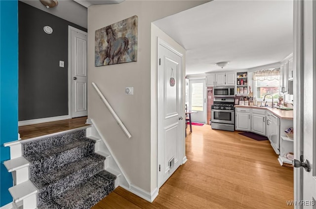 236 Commodore Ter, Cheektowaga, NY 14225 - stairs featuring wood finished floors and baseboards