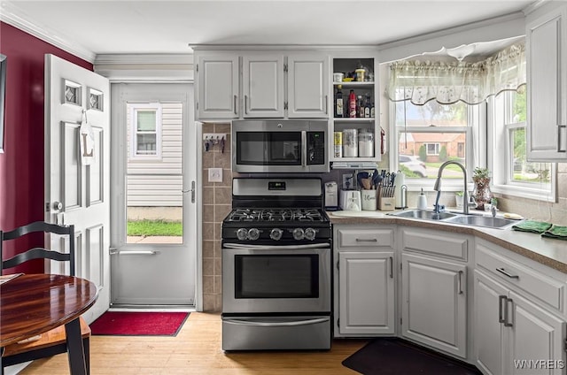 236 Commodore Ter, Cheektowaga, NY 14225 - kitchen featuring appliances with stainless steel finishes, a sink, wood finished floors, ornamental molding, and light countertops