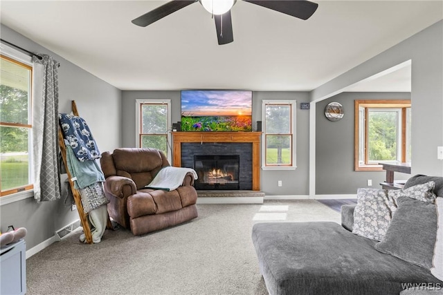 1621 Cain Rd, Brant, NY 14111 - carpeted living room featuring a ceiling fan, a lit fireplace, and baseboards