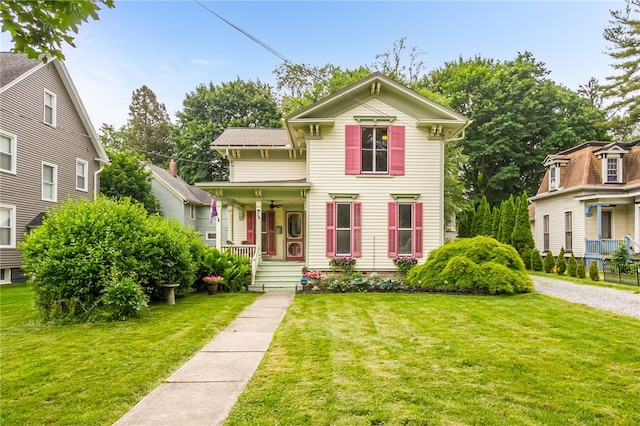 76 W Main St, Mendon, NY 14472 - italianate home with covered porch, a front lawn, and a ceiling fan