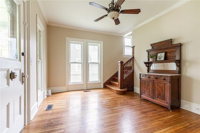 76 W Main St, Mendon, NY 14472 - entrance foyer with light wood-style flooring, crown molding, stairs, a ceiling fan, and baseboards