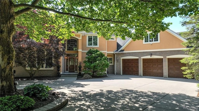 3248 Lockport Olcott Rd, Newfane, NY 14108 - view of front of house with stucco siding, driveway, and an attached garage