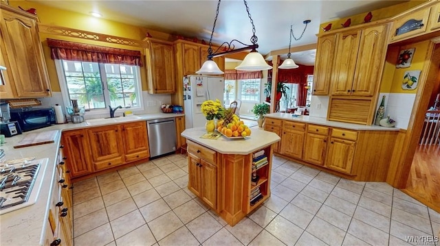 3248 Lockport Olcott Rd, Newfane, NY 14108 - kitchen with stainless steel appliances, a sink, light countertops, and pendant lighting