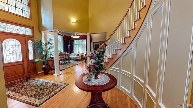 3248 Lockport Olcott Rd, Newfane, NY 14108 - foyer entrance with a towering ceiling, decorative columns, stairway, and wood finished floors