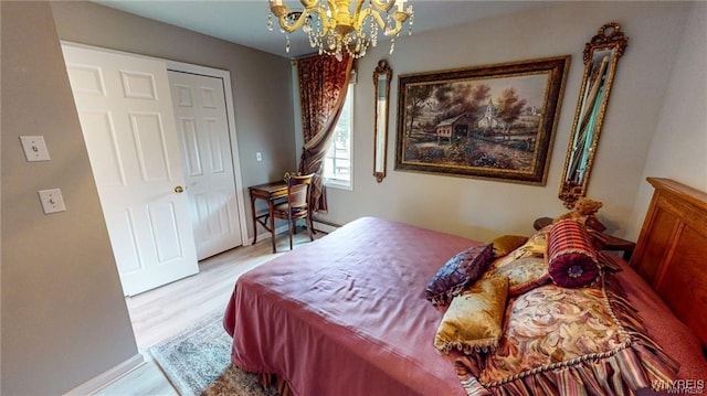 3248 Lockport Olcott Rd, Newfane, NY 14108 - bedroom featuring wood finished floors and a chandelier