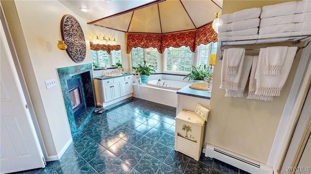 3248 Lockport Olcott Rd, Newfane, NY 14108 - full bathroom with a baseboard heating unit, vanity, a bath, a fireplace, and baseboards