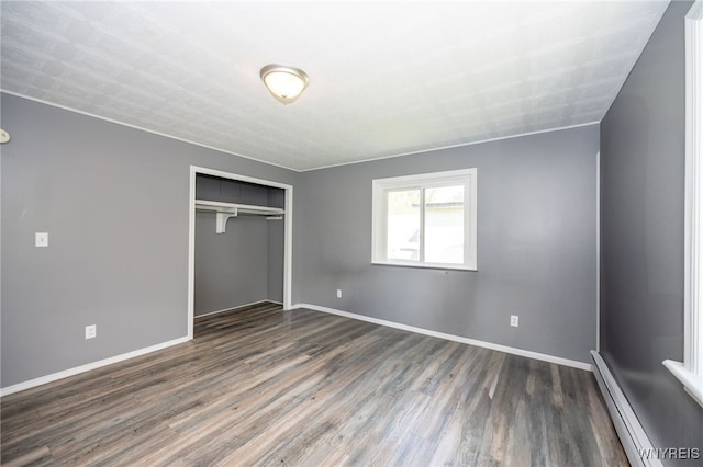 6817 Revere Dr, Evans, NY 14047 - unfurnished bedroom featuring baseboard heating, wood finished floors, and a closet