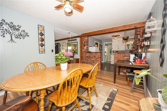 6817 Revere Dr, Evans, NY 14047 - dining room featuring light wood-style floors, ceiling fan, and a textured ceiling
