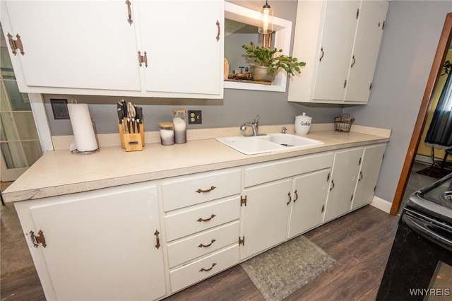 6817 Revere Dr, Evans, NY 14047 - kitchen with white cabinetry, dark wood finished floors, light countertops, and black range