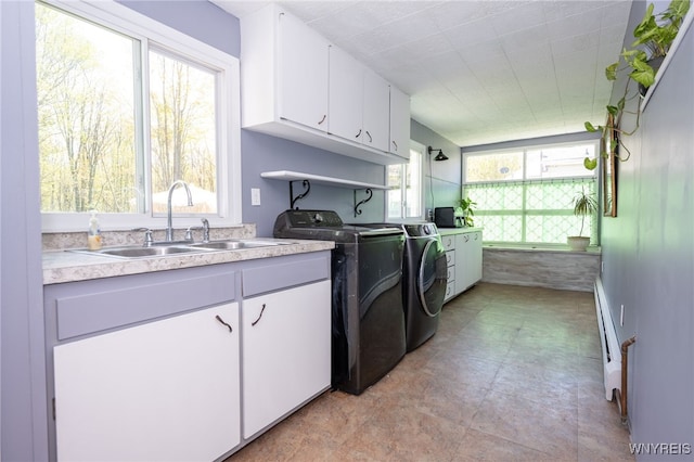 6817 Revere Dr, Evans, NY 14047 - laundry room with washer and clothes dryer and cabinet space