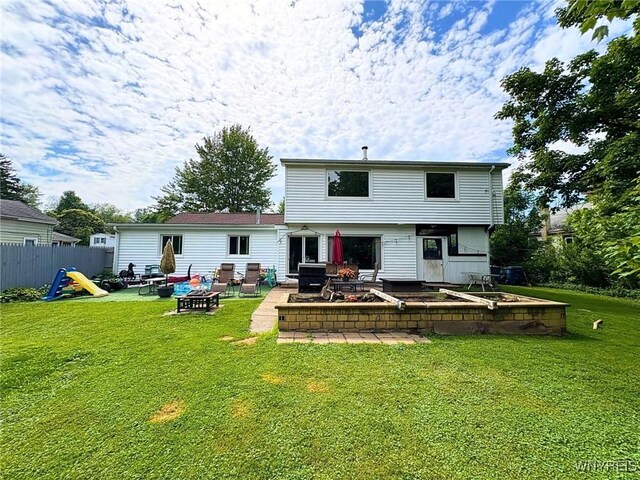 6817 Revere Dr, Evans, NY 14047 - rear view of property featuring a patio and a fire pit