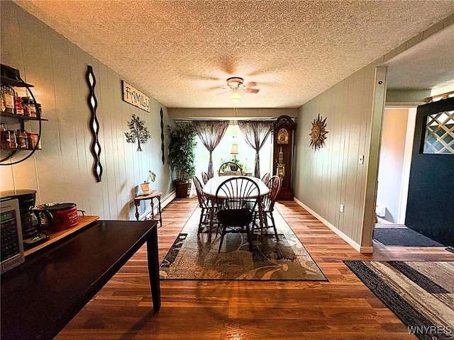 6817 Revere Dr, Evans, NY 14047 - dining room with wood finished floors, a textured ceiling, ceiling fan, and wooden walls