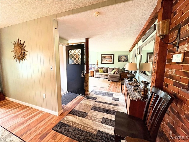 6817 Revere Dr, Evans, NY 14047 - entryway with wood finished floors, a textured ceiling, and wooden walls
