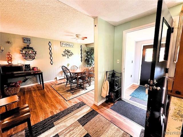 6817 Revere Dr, Evans, NY 14047 - foyer entrance featuring wood finished floors, ceiling fan, and a textured ceiling