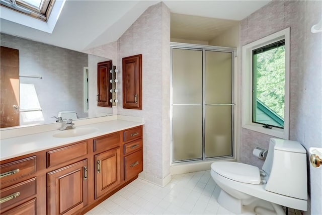 120 Scotch Ln, Irondequoit, NY 14617 - full bath featuring a skylight, toilet, vanity, tile patterned floors, and a stall shower