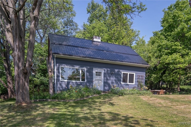 435 Elm St, Ithaca City, NY 14850 - view of home's exterior with metal roof, a yard, a chimney, and a standing seam roof