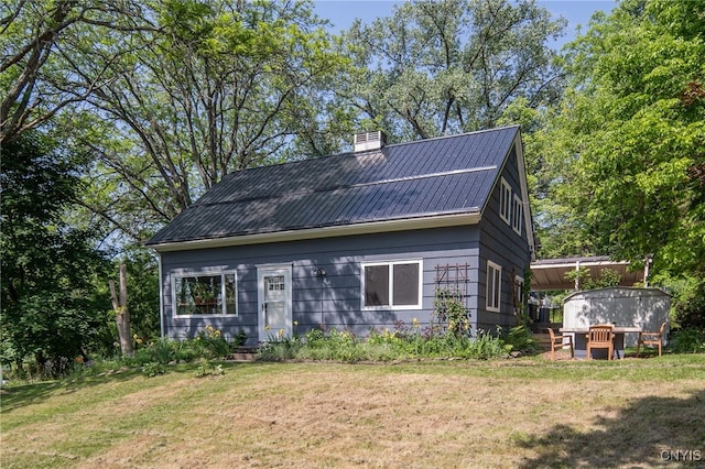 435 Elm St, Ithaca City, NY 14850 - view of front of house with a front yard, a chimney, and metal roof