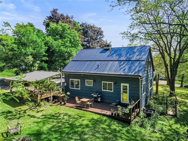 435 Elm St, Ithaca City, NY 14850 - back of property with a deck, a lawn, a chimney, and metal roof