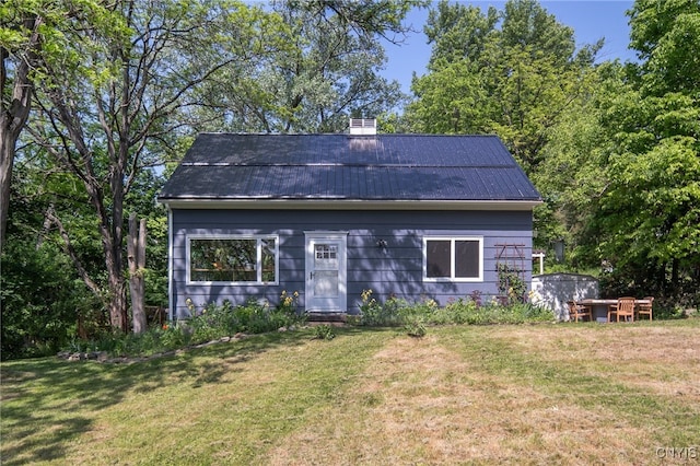435 Elm St, Ithaca City, NY 14850 - view of front facade featuring a front lawn, metal roof, and a chimney