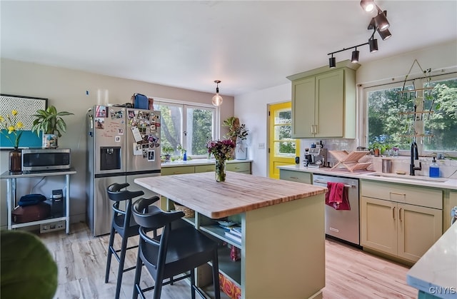 435 Elm St, Ithaca City, NY 14850 - kitchen with stainless steel appliances, a sink, butcher block countertops, a kitchen bar, and light wood-type flooring