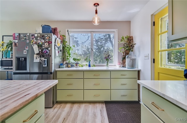 435 Elm St, Ithaca City, NY 14850 - kitchen featuring green cabinetry, appliances with stainless steel finishes, light wood-style floors, and butcher block countertops