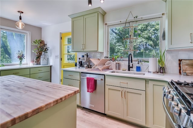 435 Elm St, Ithaca City, NY 14850 - kitchen featuring stainless steel appliances, a sink, green cabinets, and tasteful backsplash