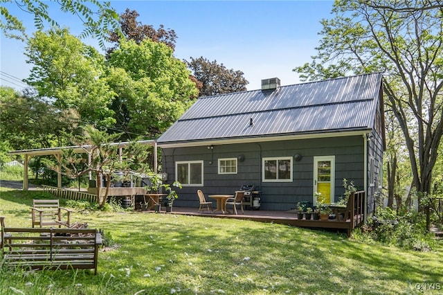 435 Elm St, Ithaca City, NY 14850 - rear view of property featuring a wooden deck, a chimney, a yard, metal roof, and central AC unit