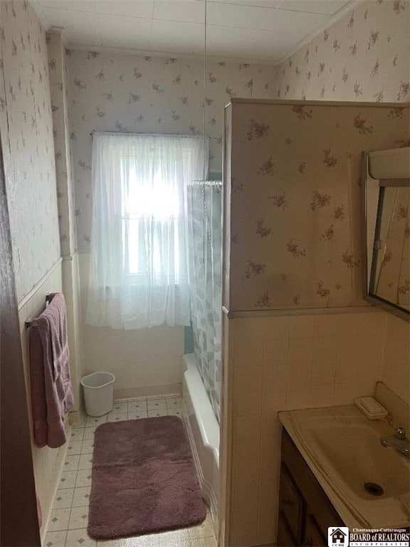 100 Eagle St, Pomfret, NY 14063 - full bath featuring wallpapered walls, wainscoting, vanity, shower / tub combo with curtain, and crown molding
