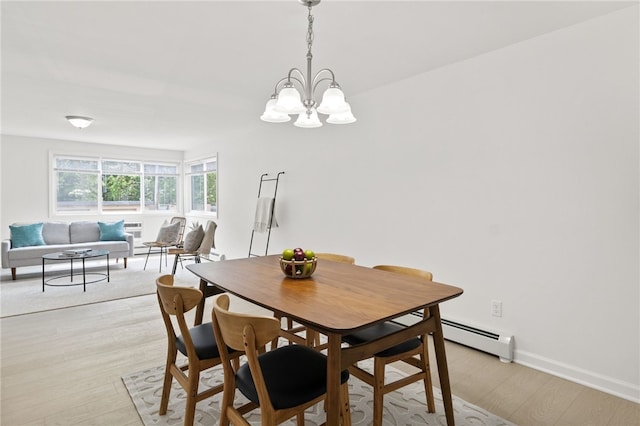406 Westage At The Hbr, Irondequoit, NY 14617 - dining space with a baseboard radiator, a chandelier, light wood-style flooring, and baseboards