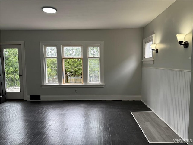 711 W Ave, Buffalo, NY 14213 - spare room with dark wood-type flooring, wainscoting, and baseboards