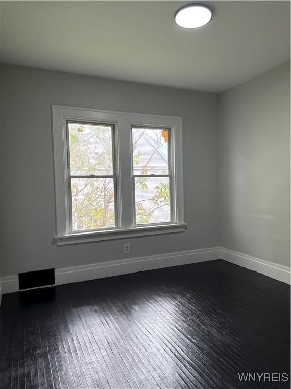 711 W Ave, Buffalo, NY 14213 - empty room with dark wood-style flooring, healthy amount of natural light, and baseboards