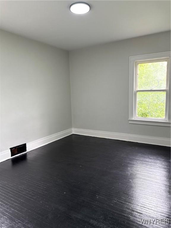 711 W Ave, Buffalo, NY 14213 - unfurnished room with baseboards and dark wood-style floors