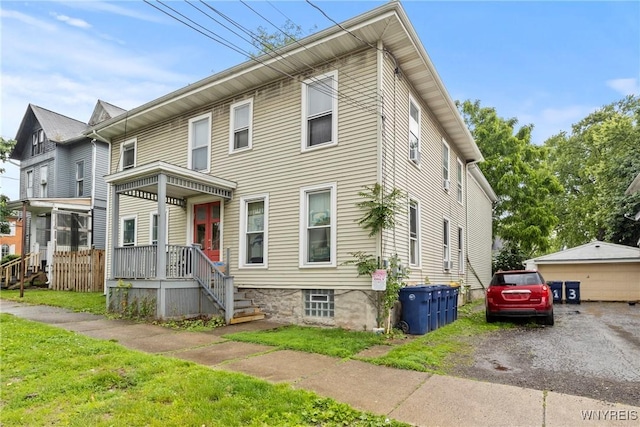 89 Pine St, Lockport-City, NY 14094 - townhome / multi-family property with a porch and a front lawn