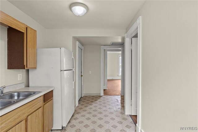 89 Pine St, Lockport-City, NY 14094 - kitchen featuring light countertops, light flooring, a sink, freestanding refrigerator, and baseboards