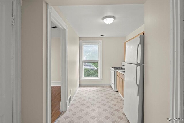 89 Pine St, Lockport-City, NY 14094 - kitchen with white appliances, baseboards, brown cabinets, light flooring, and light countertops