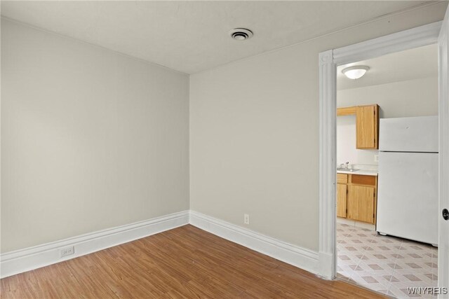89 Pine St, Lockport-City, NY 14094 - unfurnished room featuring light wood finished floors, a sink, and baseboards