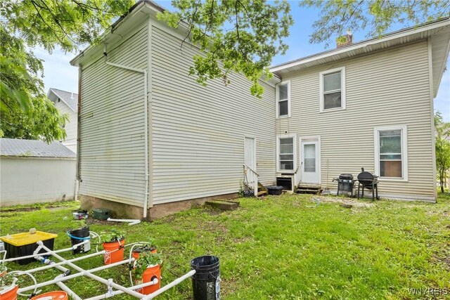 89 Pine St, Lockport-City, NY 14094 - rear view of property with entry steps and a lawn