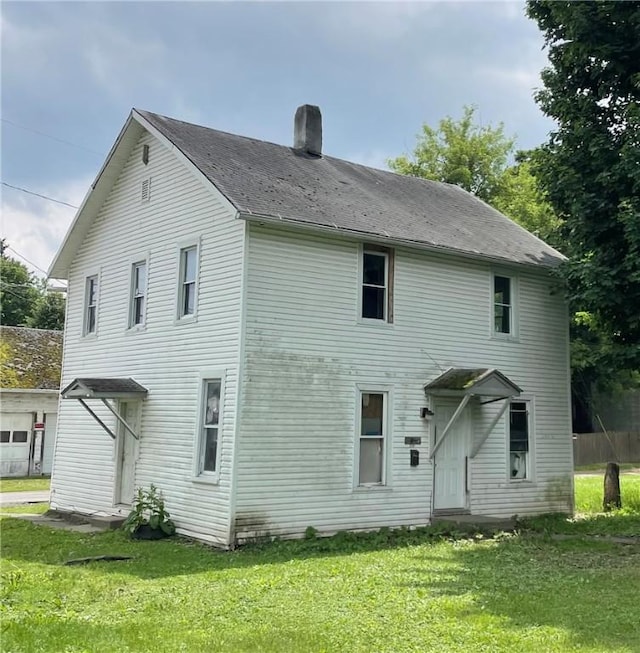 207-209-2091/2 W Chemung Pl, Elmira-City, NY 14904 - back of house featuring a chimney and a yard